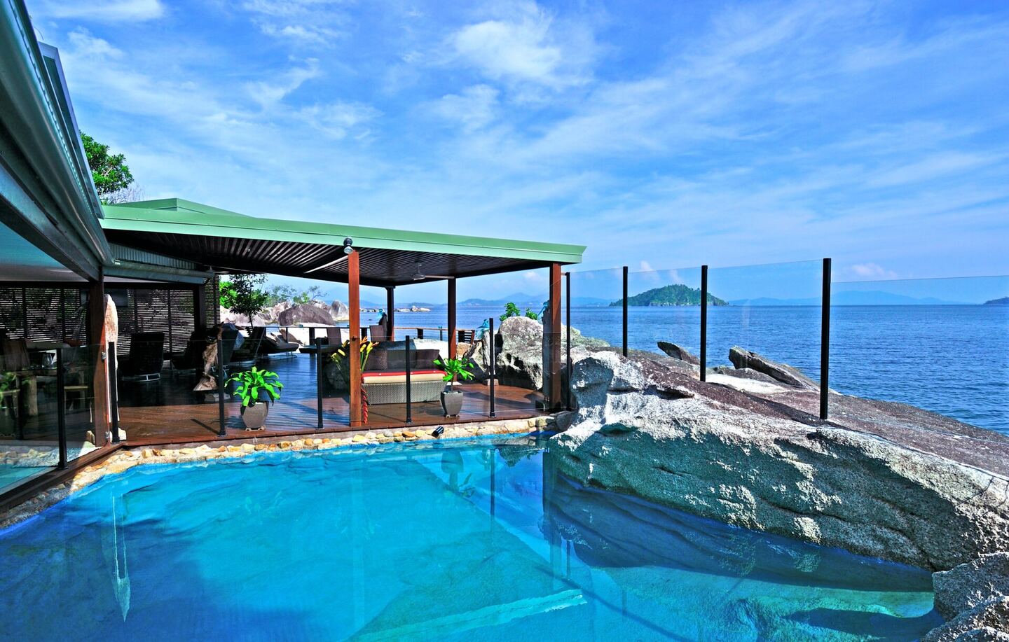 Saltwater plunge pool carved into the granite boulders overlooking the sea