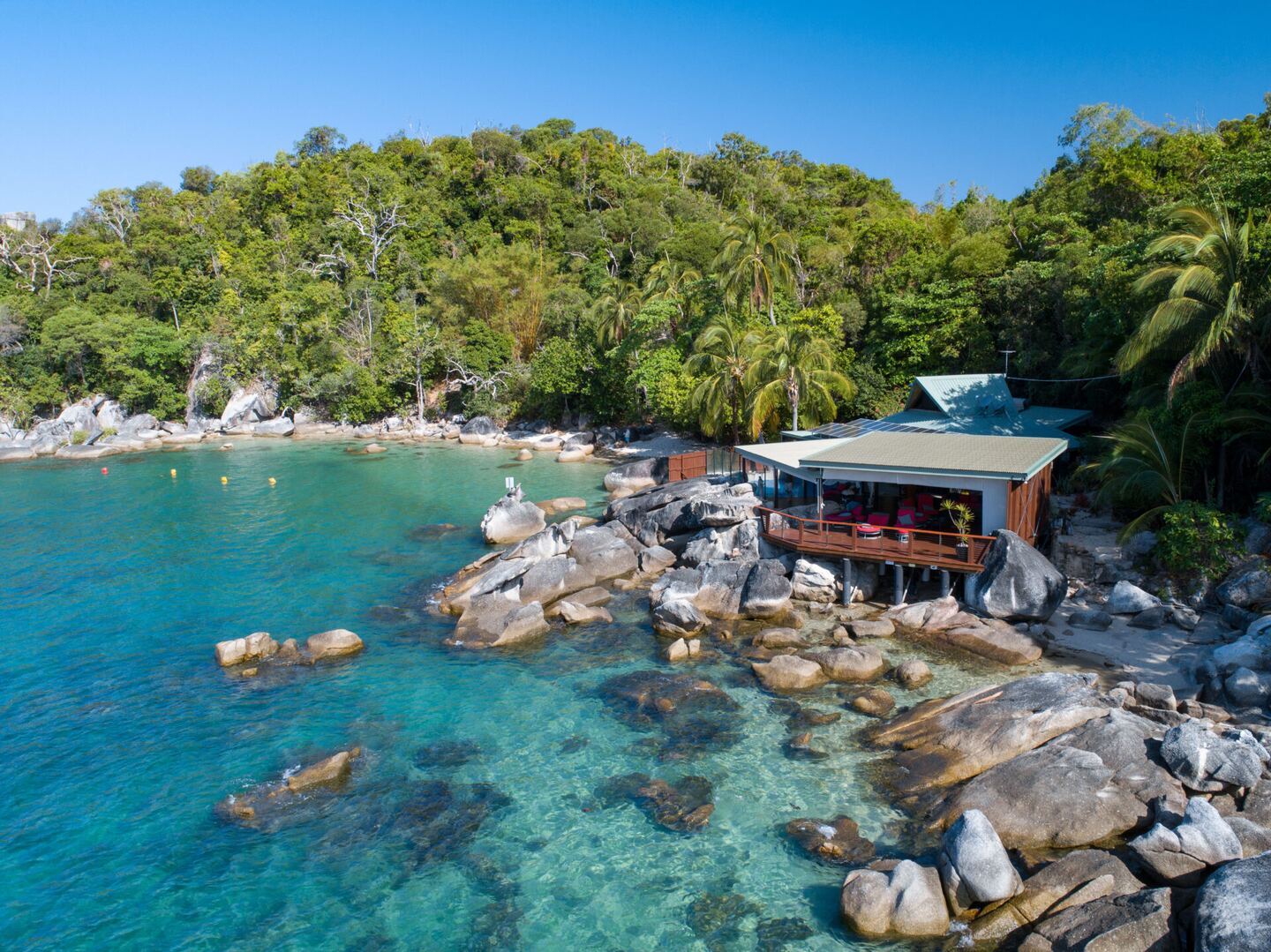 Aerial view of the retreat set above its private cove